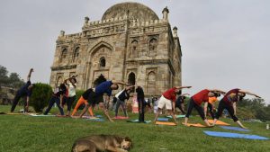 People perform yoga on International Yoga Day at Lodhi garden in New Delhi.