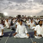 People practice asanas during a mass yoga session on the third day of Baba Ramdev Yoga camp in Ahmedabad, Gujarat on June 20, 2017.