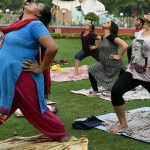 People practice yoga at a park in Lucknow, Uttar Pradesh on June 18, 2017.