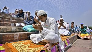 Worshippers gather on the steps of the Jama Masjid during afternoon prayers on the last Friday of Ramzan in Delhi