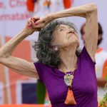 Yoga master Tao Porchon-Lynch, 98, takes part in a mass yoga session on International Yoga Day at the Shree Kanteerava Stadium in Bangalore on June 21.