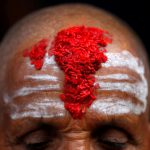 A Hindu priests forehead is covered with ‘tika’, coloured powder and rice used as a blessing, during the sacred thread festival at the Pashupatinath temple in Kathmandu, Nepal, July 28, 2017.