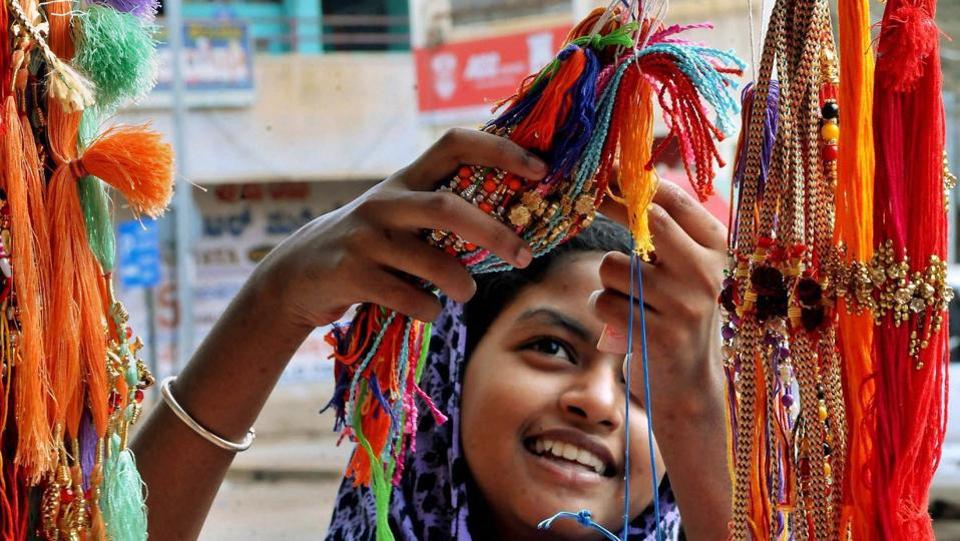 A girl selecting Rakhi at a shop in Chikmaglur, Karnataka . The craze for choosing the best rakhis for their brothers can be seen among the women and young girls.