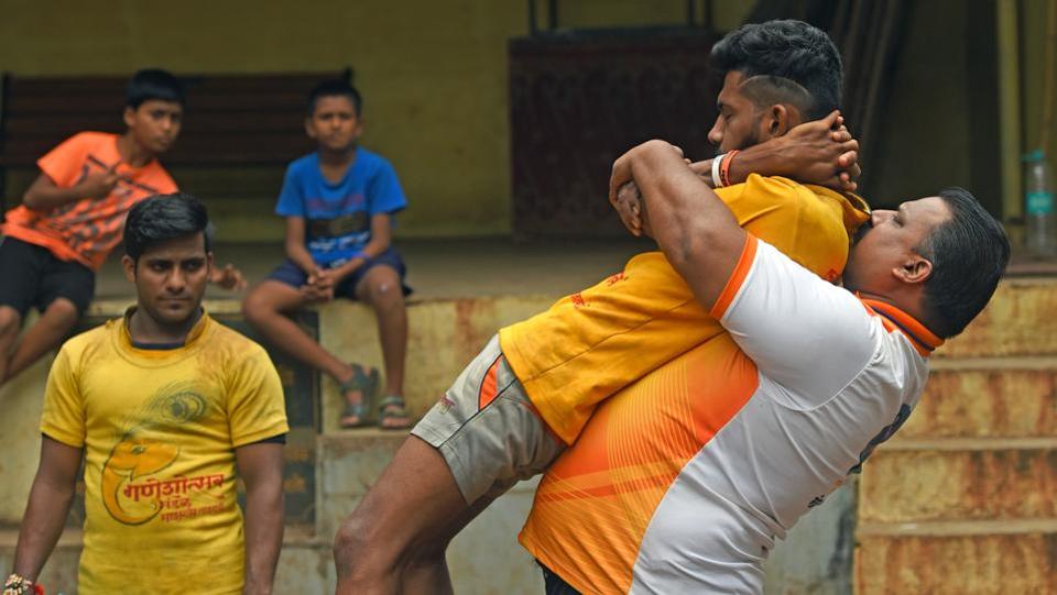 Coach Ganesh Chavan exercises with his teammates.