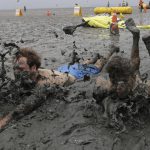 Men slide in the mud during the Boryeong Mud Festival at Daecheon Beach in Boryeong, South Korea. Started in 1998, the Boryeong Mud Festival was first put on as a PR stunt after a range of cosmetics was launched using mud from the Boryeong mud flats. The annual festival is famous for attracting the largest numbers of foreign visitors among local festivals.