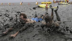 Men slide in the mud during the Boryeong Mud Festival at Daecheon Beach in Boryeong, South Korea. Started in 1998, the Boryeong Mud Festival was first put on as a PR stunt after a range of cosmetics was launched using mud from the Boryeong mud flats. The annual festival is famous for attracting the largest numbers of foreign visitors among local festivals.