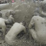 Tourists play with mud in a mud pool. The event drew roughly four million people last year, including 430,000 foreigners. The festival is estimated to have provided a regional economic impact worth 73 billion won ($65.3 million) last year