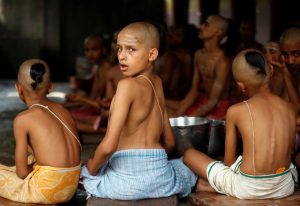 Young Hindu priests wearing sacred threads perform a ritual during the sacred thread festival at the Pashupatinath temple in Kathmandu, Nepal