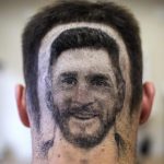 A football fan sports a hair tattoo showing the portrait of Argentinian star Lionel Messi at a hair salon in Novi Sad, Serbia