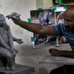 Artist Vishal Shinde works on a clay idol.