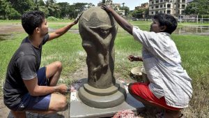 Artists prepare a clay model of FIFA World Cup trophy in Kolkata. (PTI)1/9 Artists prepare a clay model of FIFA World Cup trophy in Kolkata