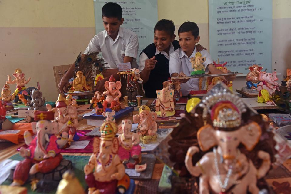 Students of New English School display idols made by them for sale at the campus in Pune.