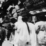 Women pass by one of the bazars of Delhi, with its storefronts decorated with the Indian national flag on August 15, 1947.