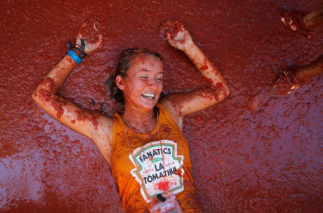 A reveller lies in tomato pulp during the annual ‘La Tomatina’ tomato food fight festival in Bunol, near Valencia, Spain on August 28, 2019.