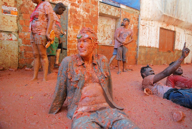 A reveller sits in tomato pulp during the annual ‘La Tomatina’ food fight festival in Bunol, near Valencia, Spain on August 28, 2019.