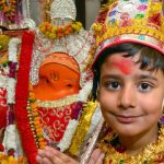 Children dressed as langoor offer prayers during the Langoor Festival at the Bada Hanuman Mandir in the Durgiana Temple complex in Amritsar