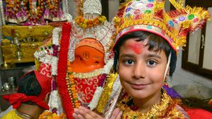 Children dressed as langoor offer prayers during the Langoor Festival at the Bada Hanuman Mandir in the Durgiana Temple complex in Amritsar