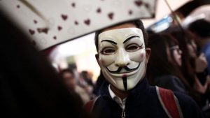 A man wearing an Anonymous mask takes part in a Halloween parade in Tokyo.