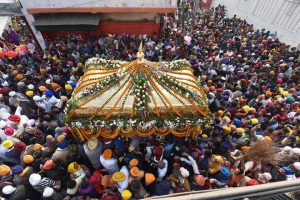 Sikh devotees carry a palanquin in a procession at the Gay Ghat Gurdwara on the occasion of 350th birth anniversary of Guru Gobind Singh in Patna on December 25, 2017