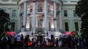 US President Donald Trump and First Lady Melania Trump hand out candy to children during a Halloween event at the decked out White House in Washington. Kids from over 20 schools in the District of Columbia, Maryland and Virginia attended the celebrations on the South Lawn along with military families and members of community organisations.