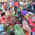 Women in groups perform Chhat Puja at Chinchwad ghat in Pune