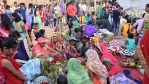Women in groups perform Chhat Puja at Chinchwad ghat in Pune