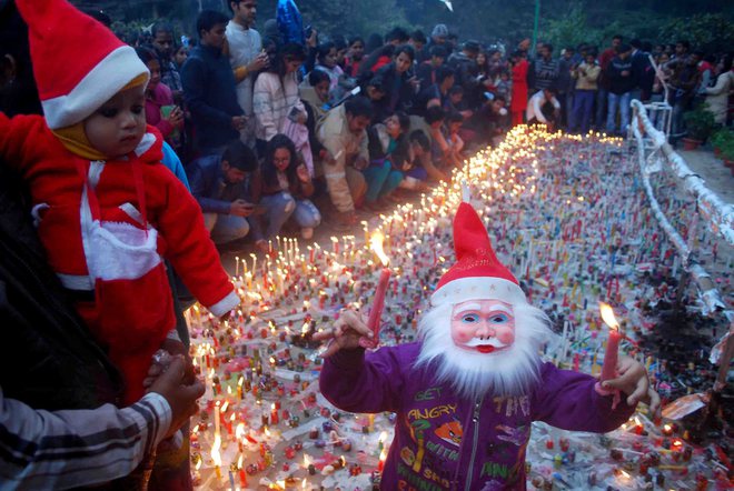 People light candles at All Saints Cathedral Church, also known as Patthar Girja, on the occasion of Christmas festival, in Allahabad on December 25, 2017