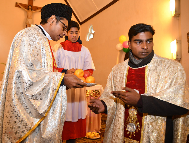 Priests lead prayers during Christmas celebrations at the Holy Family Catholic Church in Srinagar on December 25, 2015