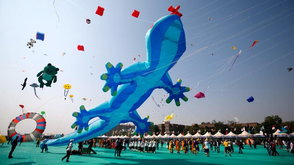 Kite-flying enthusiasts fly kites on the first day of the eight-day-long International Kite Festival in Ahmedabad.