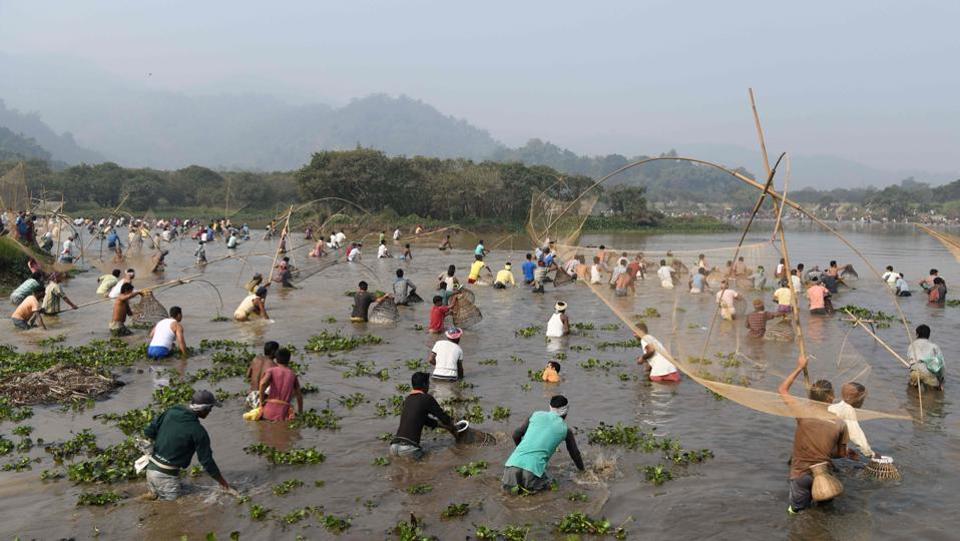 Villagers take part a community fishing event during Bhogali Bihu celebrations at Goroimari Lake in Panbari, Guwahati.
