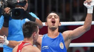 Amit Panghal gestures after defeating Uzbekistan Hasanboy Dusmatov during the Men's light fly boxing final bout