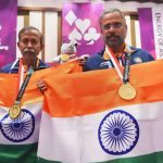 Gold medallist Pranab Bardhan and Shibhnath Sarkar pose with the Indian tricolour after winning in bridge competition