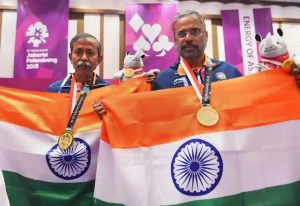 Gold medallist Pranab Bardhan and Shibhnath Sarkar pose with the Indian tricolour after winning in bridge competition