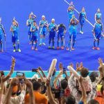 Indian men's hockey players celebrate with supporters on winning the bronze medal after defeating Pakistan 2-1