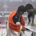 Neeraj Chopra shakes hands with bronze medallist Pakistani Arshad Nadeem during the victory ceremony for the men's javelin throw athletics event