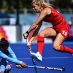 Sophie Bray of England jumps as Deep Grace Ekka of India hits the ball during the womens field hockey match between India and England at the 2018 Gold Coast Commonwealth Games