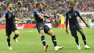 France's Kylian Mbappe, center, celebrates after scoring his side's fourth goal