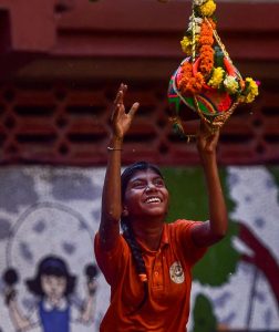 A student from Kamla Mehta School for the Blind attempt to break Dahi Handi during Janmashtami festival celebrations in Mumbai