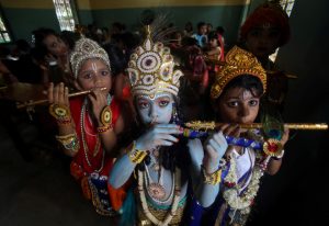 Children dressed up as Hindu Lord Krishna pose during Janmashtami festival celebrations inside a school in Agartala