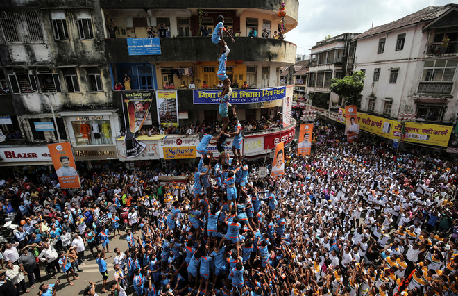 Devotees form a human pyramid to break a clay pot containing curd during the Hindu festival of Janmashtami, marking the birth anniversary of Hindu Lord Krishna, in Mumbai