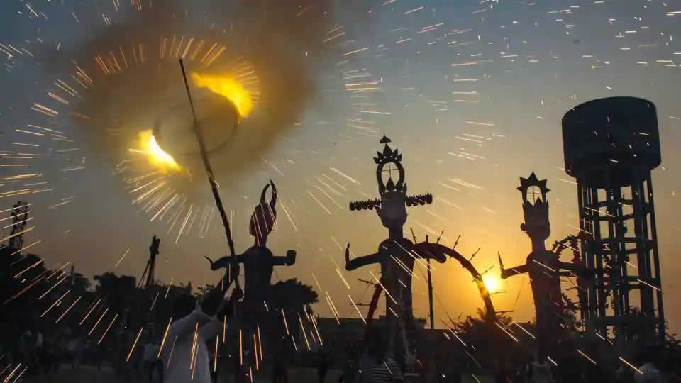 Firecrackers burst near the effigies of demon king Ravana, Meghnad and Kumbhkaran before they were set on fire in Bathinda
