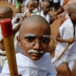 Indian school children with their head tonsured and dressed like Mahatma Gandhi assemble during a event at a school in Chennai on October 1, 2018, ahead of Gandhi's 149th birth anniversary. - Indians all over the country celebrate Gandhi's birthday on October 2.