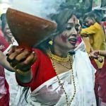 Women wearing traditional Bengali dress perform dhunuchi dance during the immersion procession of goddess Durga at Bagbazar in North Kolkata
