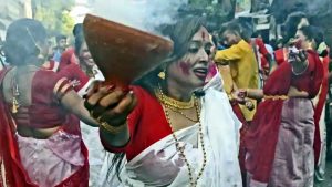 Women wearing traditional Bengali dress perform dhunuchi dance during the immersion procession of goddess Durga at Bagbazar in North Kolkata