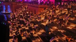 Participants light earthen oil lamps on the banks of the Sarayu river in an attempt to enter the Guinness World Records for the largest display of oil lamps on the eve of Diwali in Ayodhya.