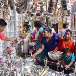 People buy utensils at a shop on the occasion of Dhanteras festival, in Allahabad