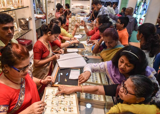 Women buy gold ornaments on the occasion of Dhanteras, in Kolkata