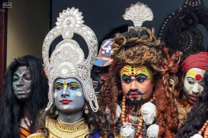 An artist dressed as Hindu god Lord Shiva and others take part in a religious procession on the occasion of Maha Shivaratri festival, in Allahabad