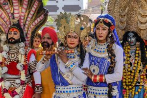 Artists dressed as Hindu deities Shiva, Mata Kali, Krishna and Radha pose as they take part in a religious procession on the occasion of Maha Shivaratri festival, in Amritsar