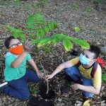 Colombian environmentalist Francisco Vera (L) plants a tree with a fellow activist to mark Earth Day, in Villeta, Colombia